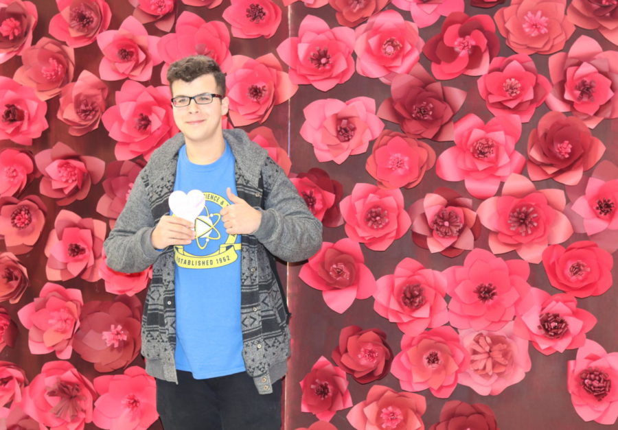 Ismail Kakakhel posing for the camera for Beauty Week in front of StuCos hand-made rose wall!