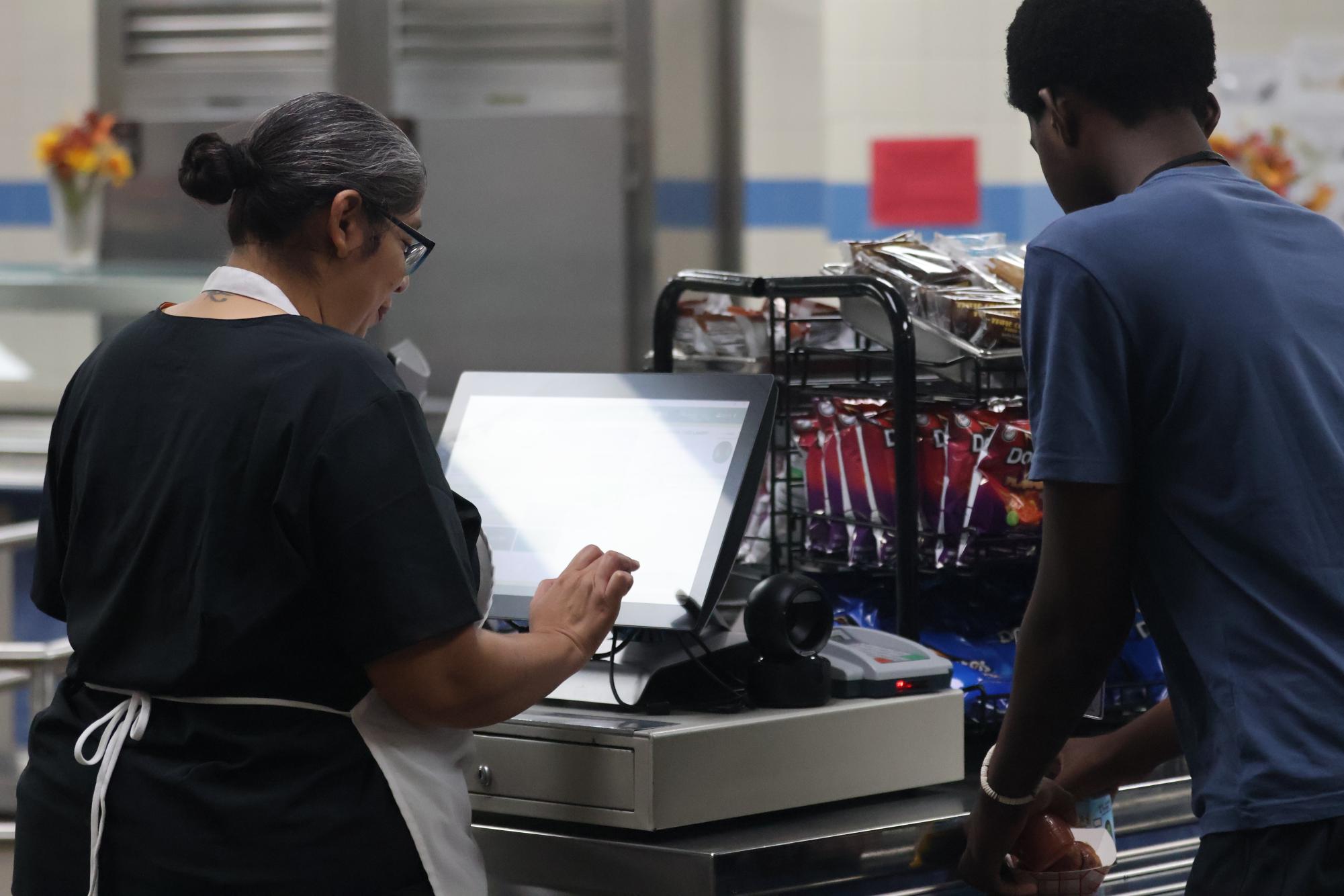 Erika Coleman helps a student check out their food at the cash register. Students can expect a "happy birthday" if they buy lunch on their birthday.