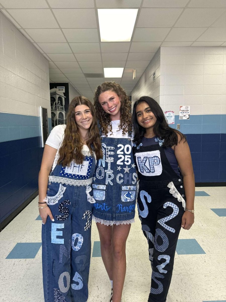 Seniors Harper Houston, Hannah Hunter, and Kareena Patel pose in their senior overalls.