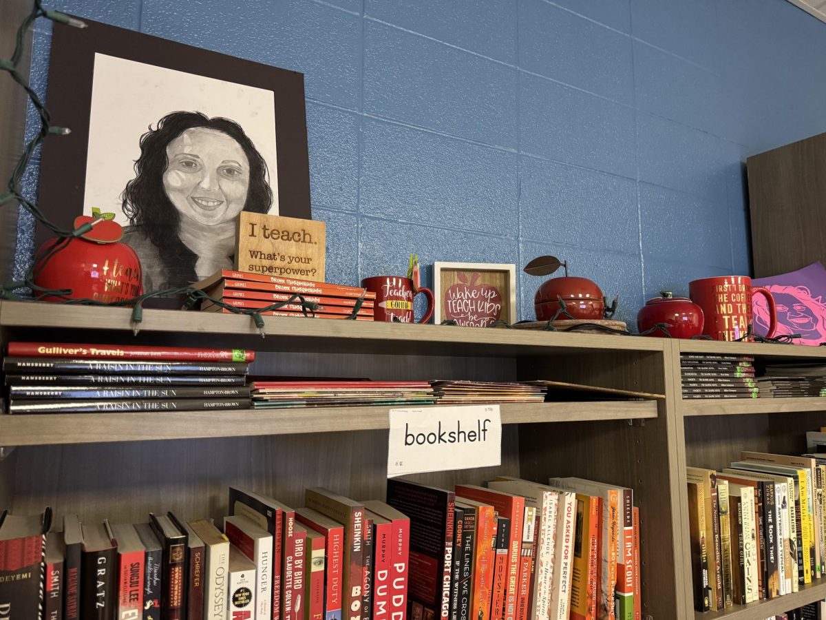 English as a Second Language teacher Anitra Shaw's portrait rests on top of a bookshelf in Shaw's classroom. Shaw said that overcoming cultural barriers through the language-learning process makes you a "better person, if you allow it to".