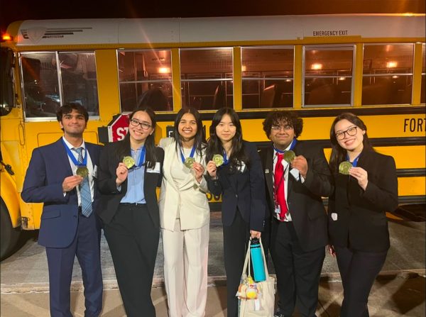 DECA students celebrate with their medals after districts, which were held on Jan. 16. Senior Aditi Srivatsan, who competed in a written event, said DECA changed her life. 