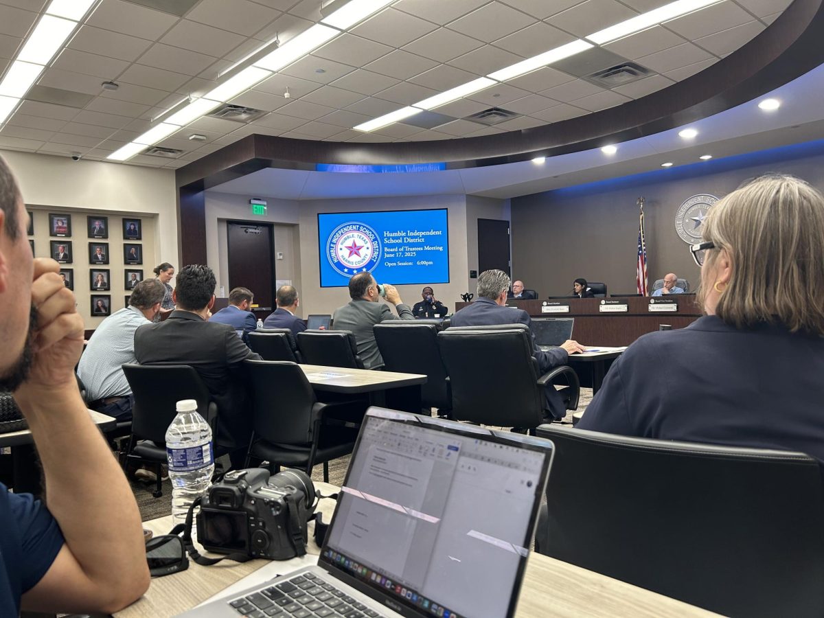 Hu shadowing another reporter at a Humble ISD board meeting.