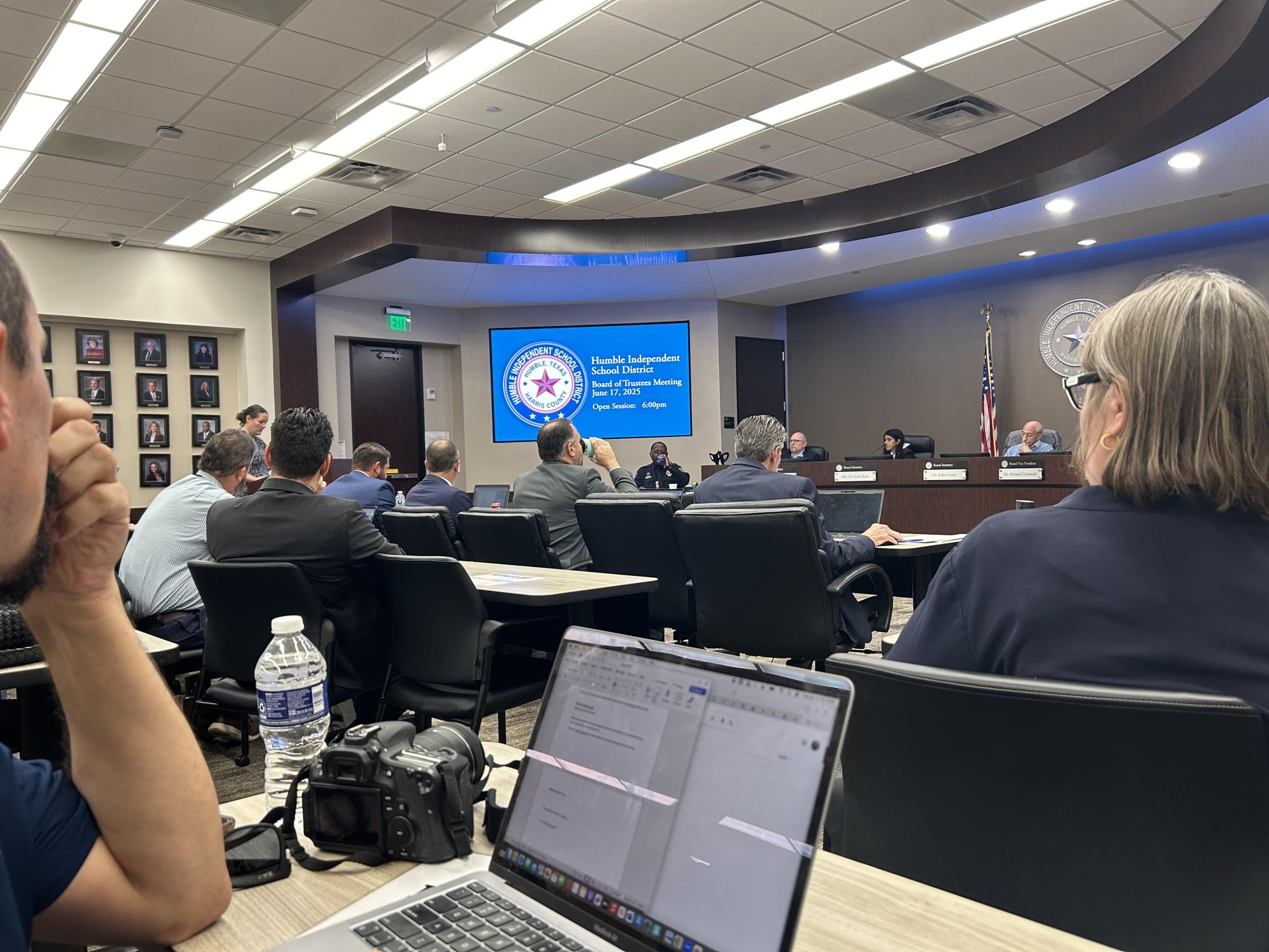 Hu shadowing another reporter at a Humble ISD board meeting.