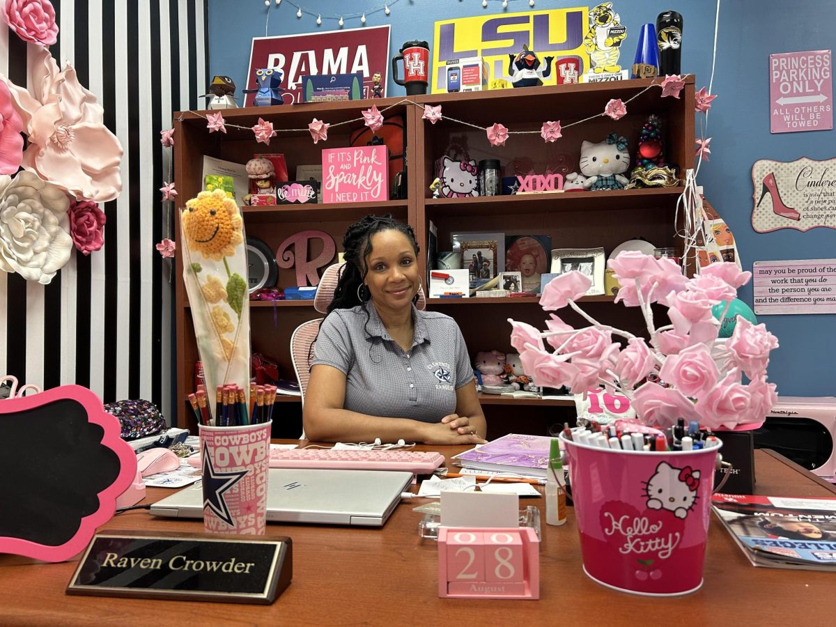 College advisor Raven Hollins-Crowder at her desk, once bare but now lively and bursting with personality.
