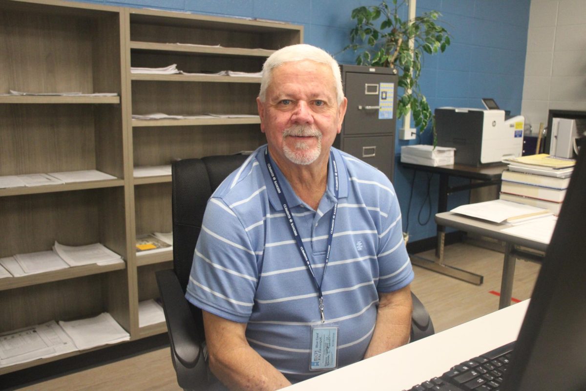 Special Education teacher Kenneth Ballinger sitting in his classroom.