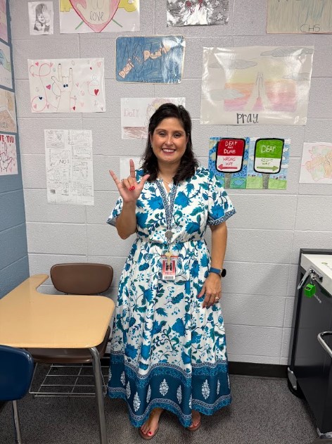 American Sign Language teacher Mrs. Campbell signs “I love you."