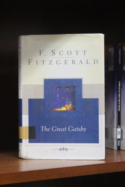 A copy of F. Scott Fitzgerald's "The Great Gatsby" neatly sitting on the library shelf, waiting for then next student to check it out.