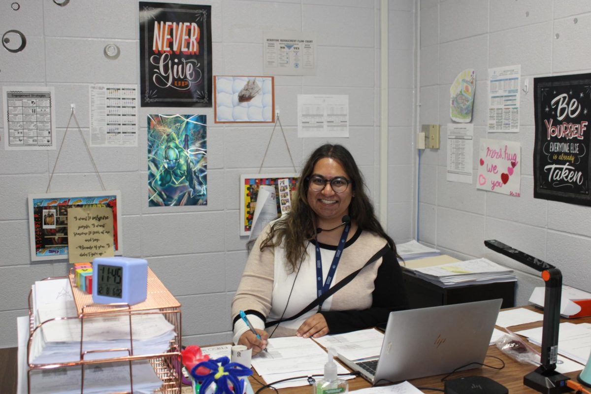 Huq sits at her desk, ready to help students with math. 