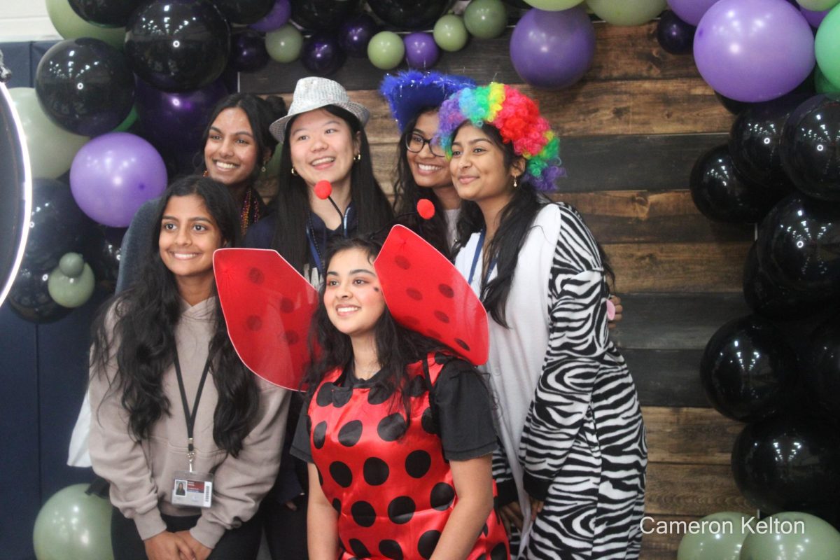 Seniors taking a group photo at Senior Boo Bash's photo booth.