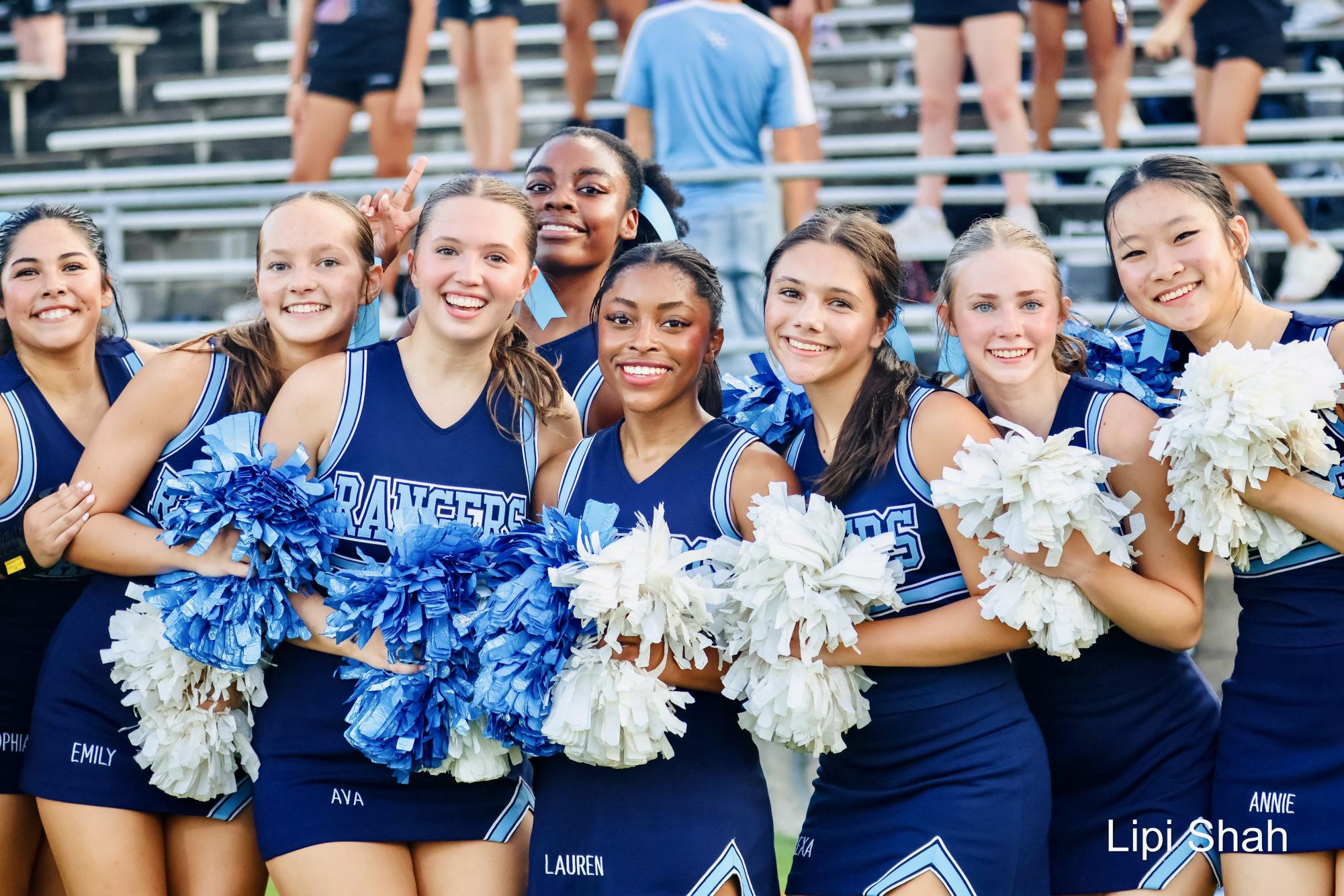 Varsity cheerleaders pose for a photo at the first game of the season.