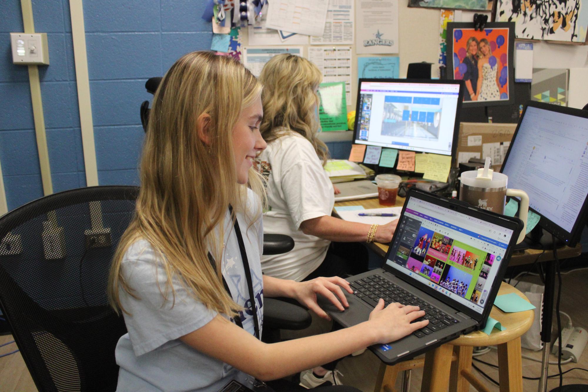 Editor-in-chief Isabel Mayo creating spreads on Yearbook Avenue, while adviser Fay Mayo works on a new spread.