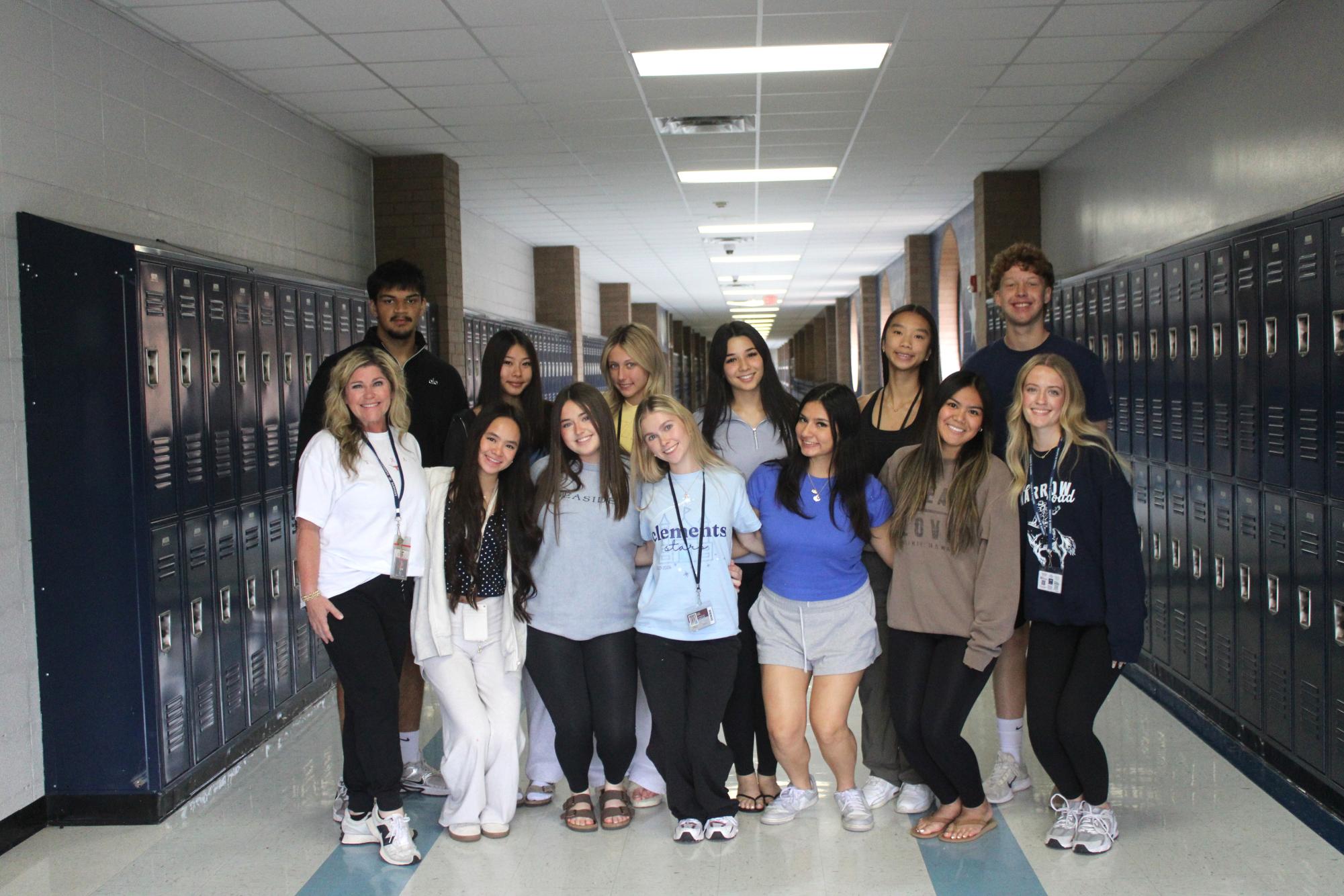 The 2026 yearbook staff standing together for a hallway group photo. 