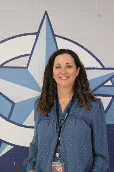 Tara McMartin poses in front of a Clements Rangers Star dressed in blue to show her school spirit. 