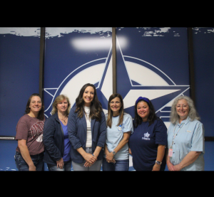 The front office staff grouped in front of the Clements' star.